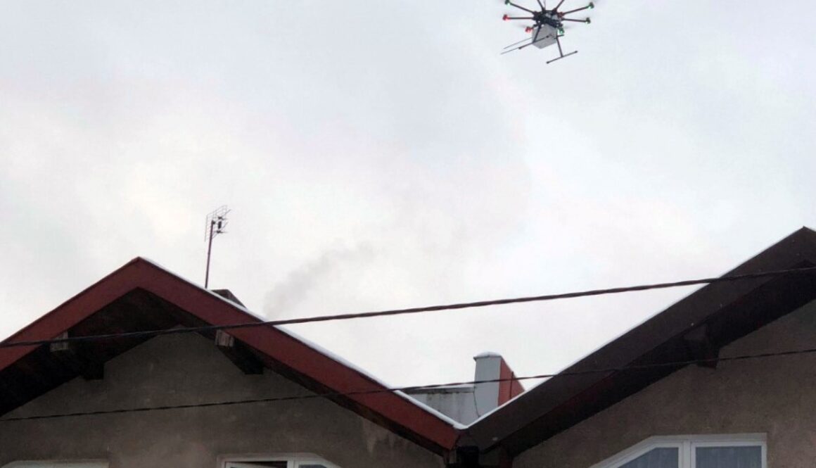 Dron kontrolujący czystość powietrza nad dachem domu jednorodzinnego