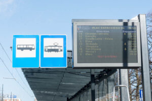 Tablica informacyjna z przyjazdami autobusów i tramwajów na przystanku w Toruniu