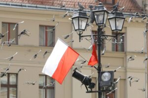Biało-czerwone flagi na Rynku Staromiejskim w Toruniu z okazji święta Konstytucji 3 Maja.